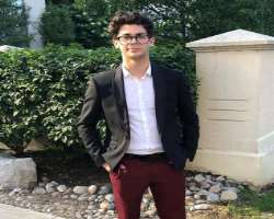 Julian is often seen wearing glasses in his posts.